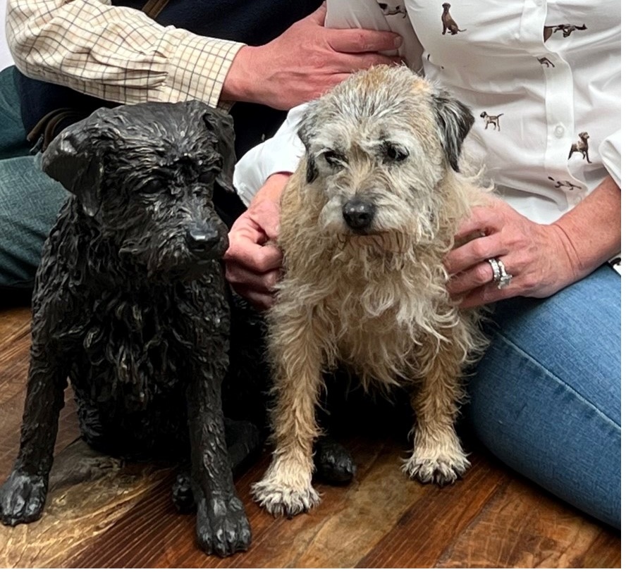 Millie the Border Terrier meets her bronze statue by the Sculptress JOEL