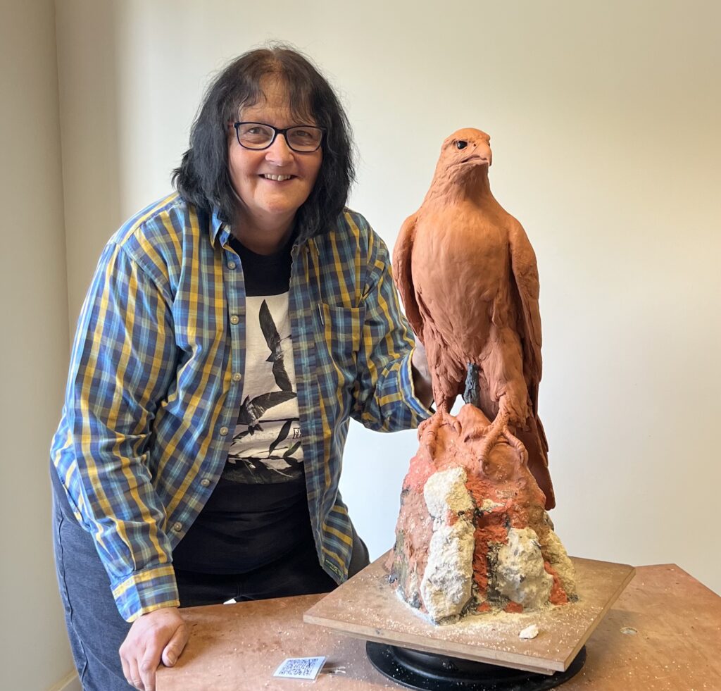 Sculptor and the finished statue of the Gyr Falcon